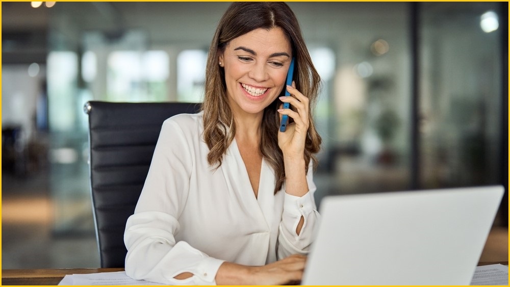 Man smiling and speaking on a mobile phone.