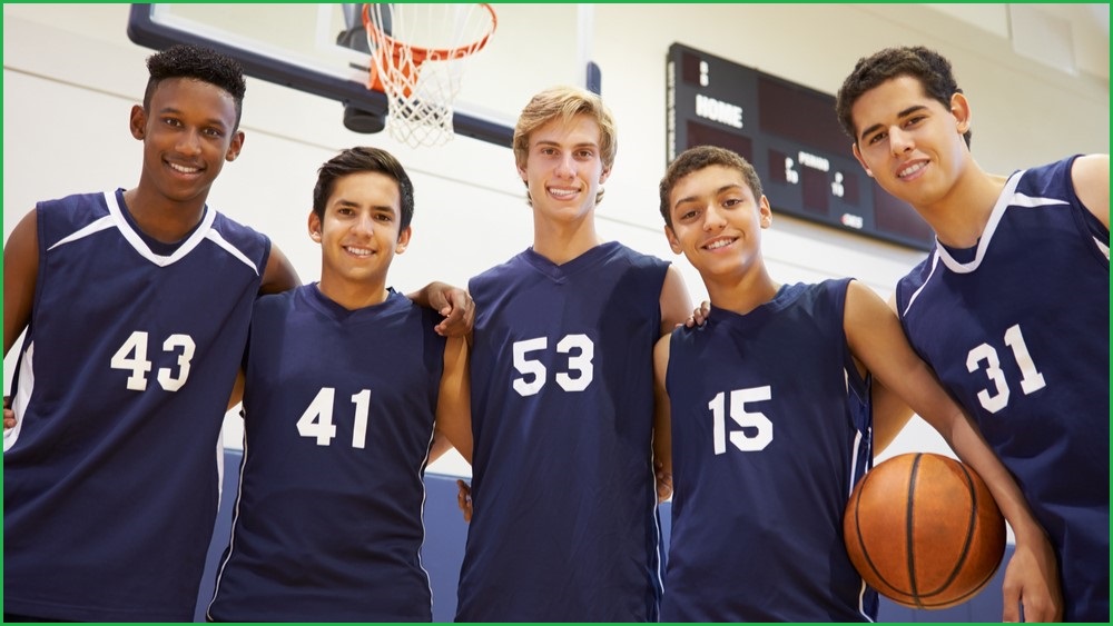 A group of five teenage basketballer males.