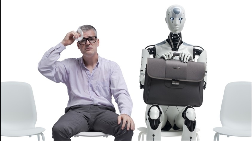 A stressed, sweating man sitting next to a robot, awaiting a job interview.