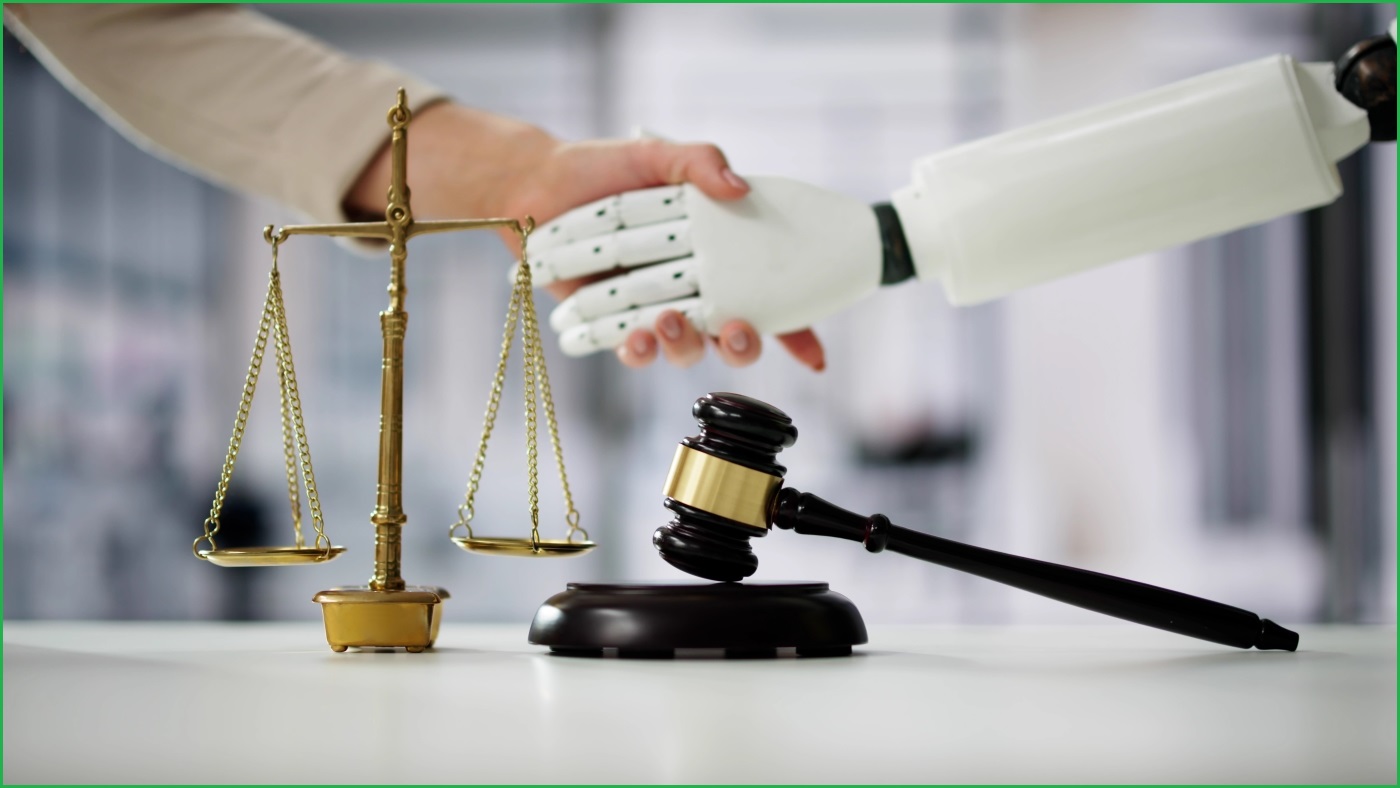 A close up of scales and a gavel on a table, in front of a human hand shaking hands with a robotic hand.