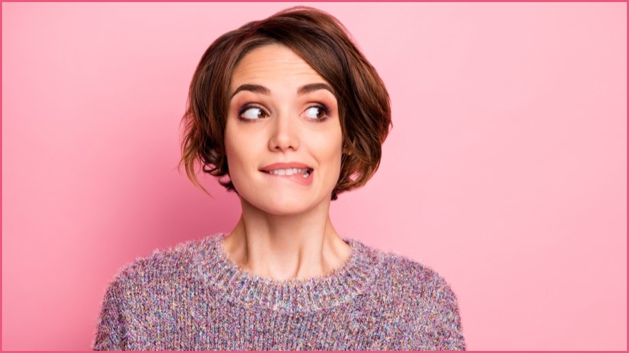 Woman biting her lip, looking to the left.