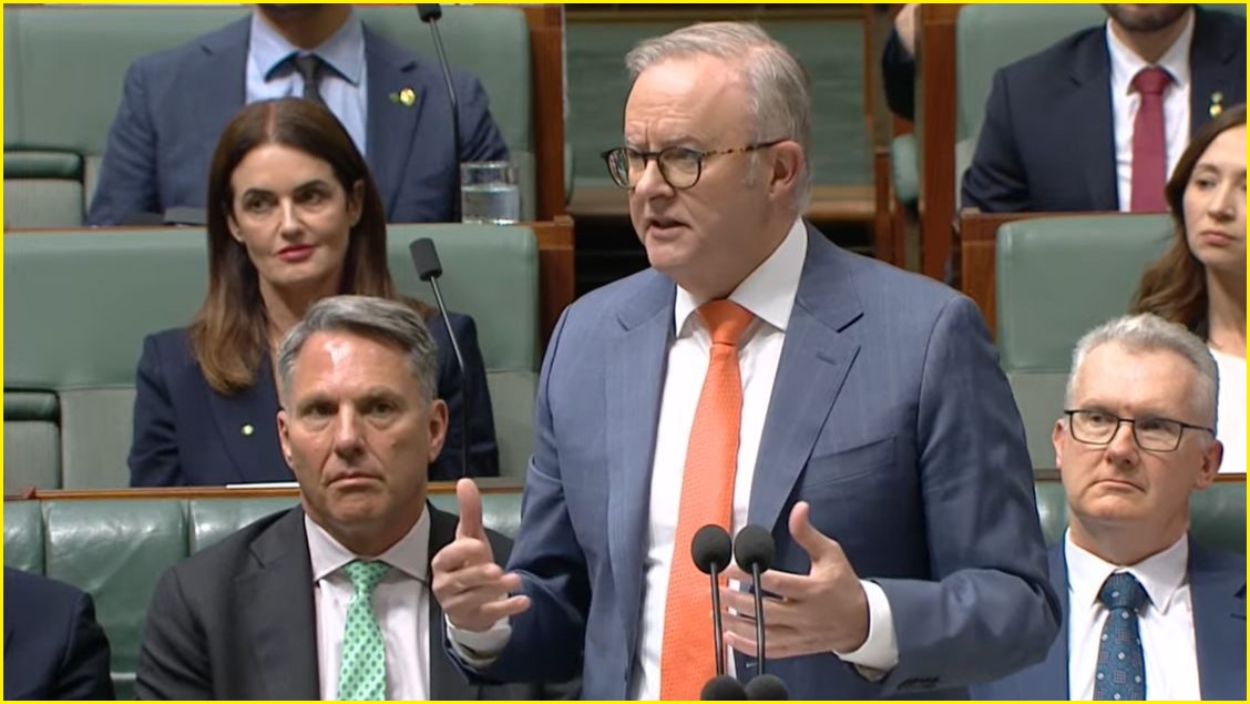 A medium shot of Anthony Albanese in a suit and tie speaking in parliament.