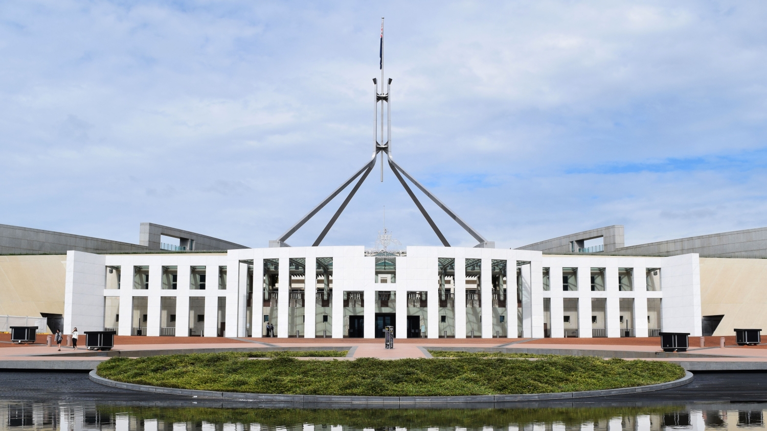 A wide outdoor shot of the Australian Parliament House building in Canberra.