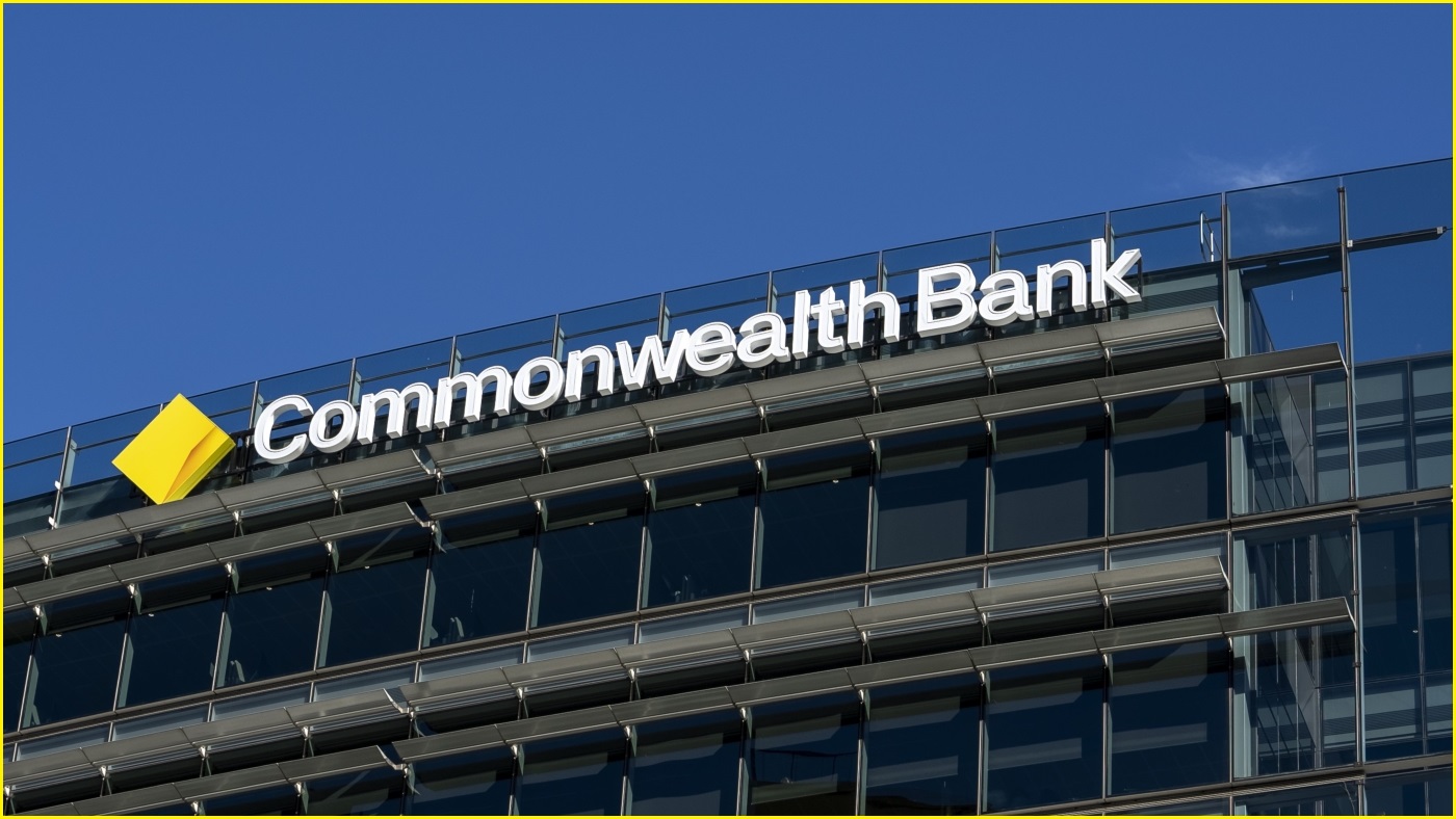 A close up of the Commonwealth Bank logo at the top of a large Commonwealth Bank building.