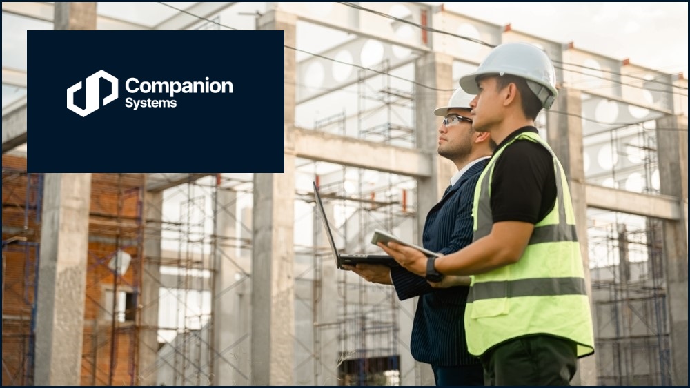 Two men on a construction site with the Companion Systems logo