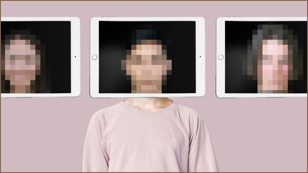 Woman with blurred face and an iPad screen framing her face.