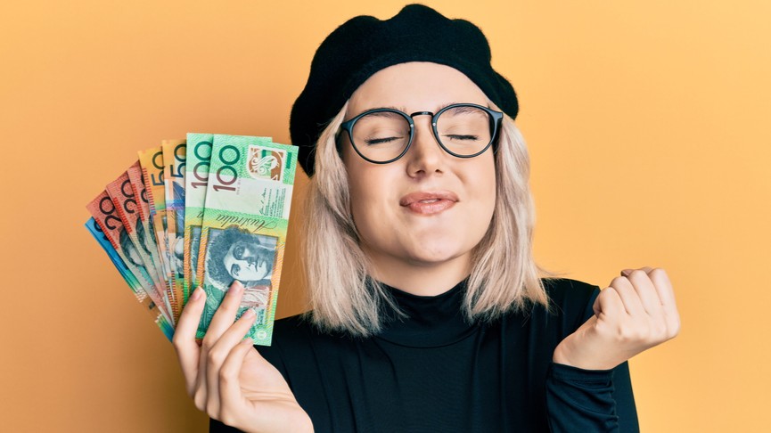 Woman holding a fanned out bunch of Australian dollars.