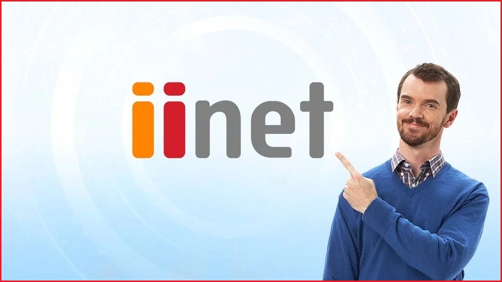 Smiling man pointint to the iiNet logo.