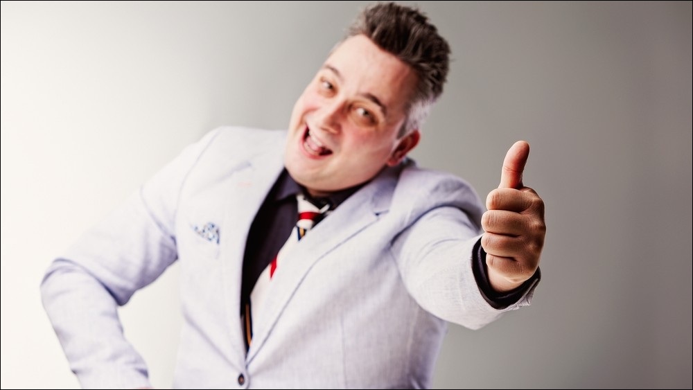 Cheesy salesman showing a thumbs up.