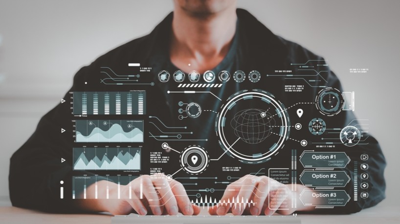 Man sitting at computer typing on keyboard.
