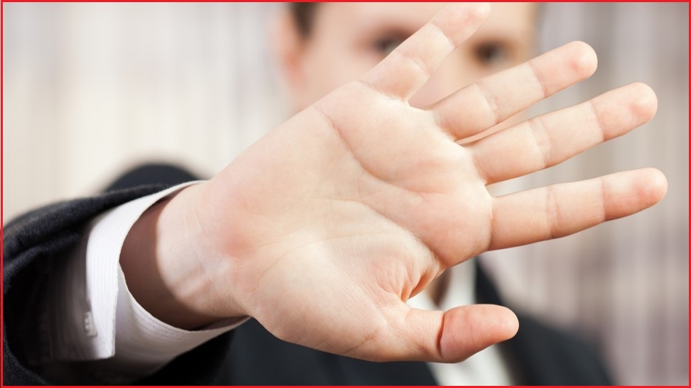 A man covering his face with his hand.