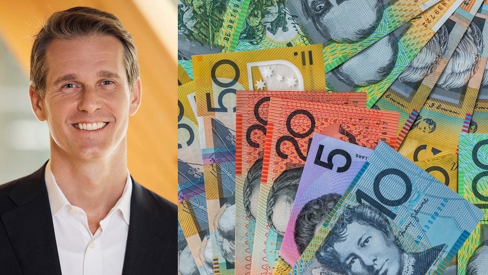 Andrew Charlton next to a a bunch of Australian dollars.