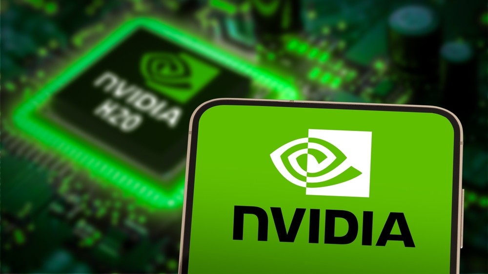 An Nvidia chip next to a phone screen displaying the Nvidia logo. 