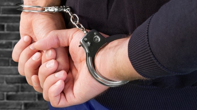 A pair of handcuffed hands.