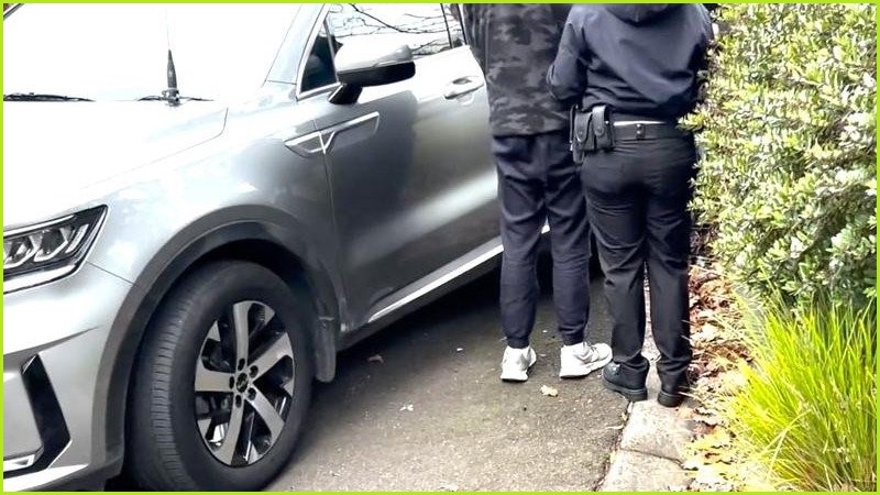 Police officer arresting Ryan Cho