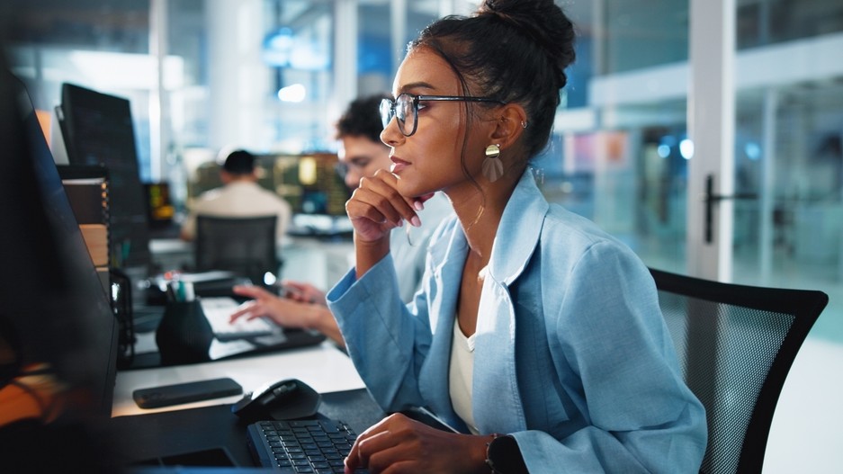 Female tech worker looking at a screen.