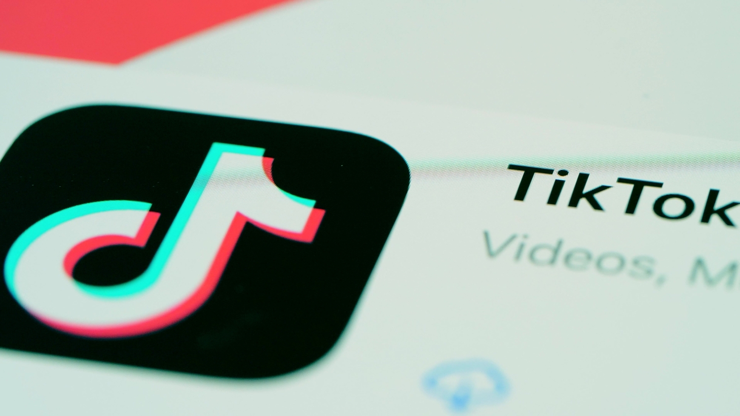 A close up of the TikTok app logo and name seen in the Apple App Store on an iPhone screen.
