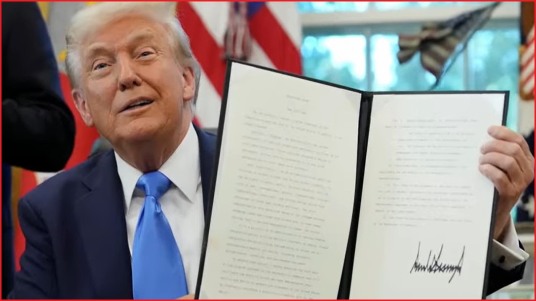 US President Donald Trump holding the signed policy.