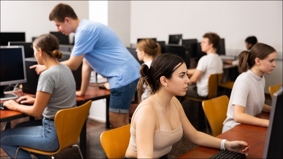 University classroom of students sitting at computer.