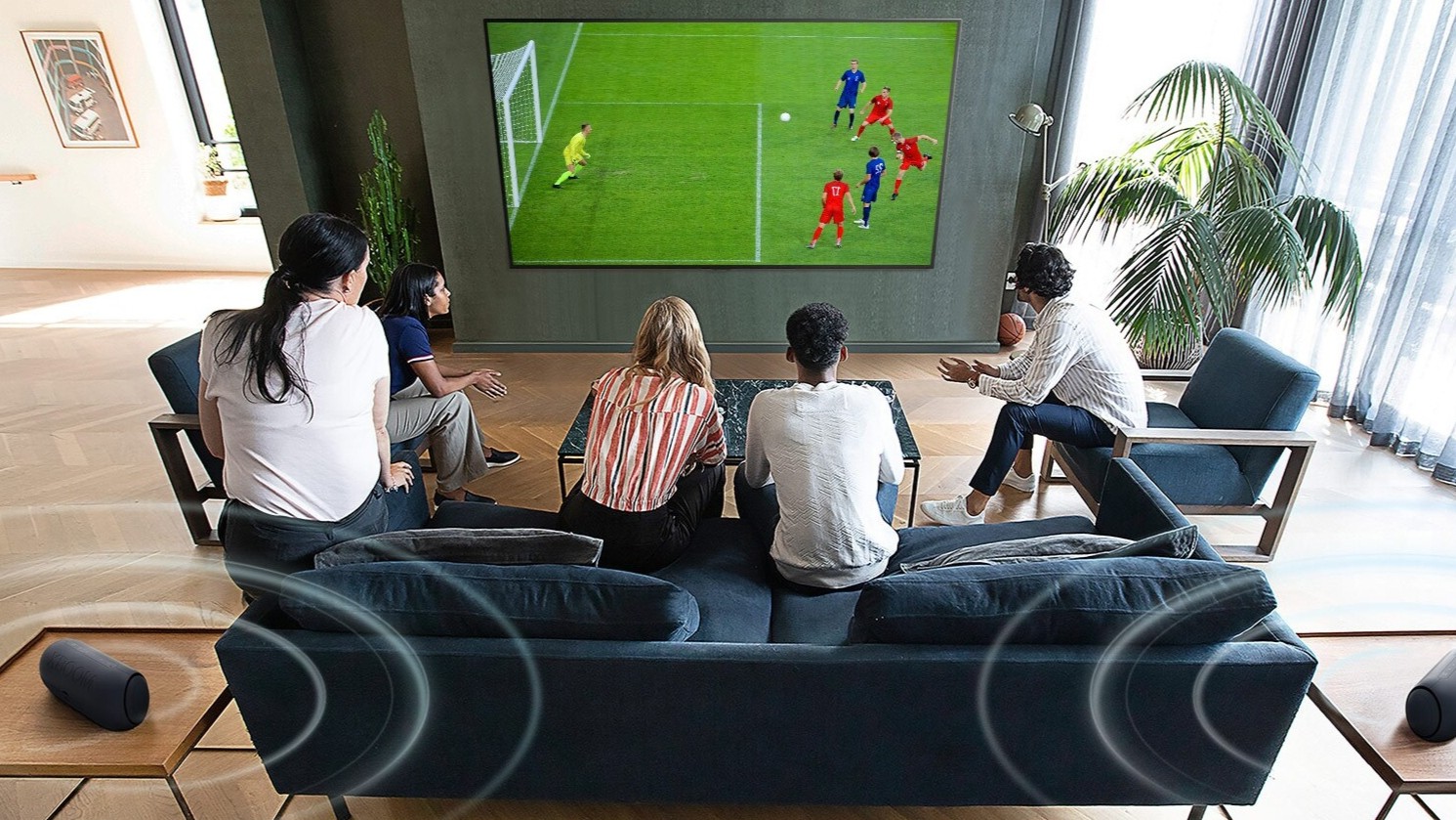 A group of people watching an LG TV.