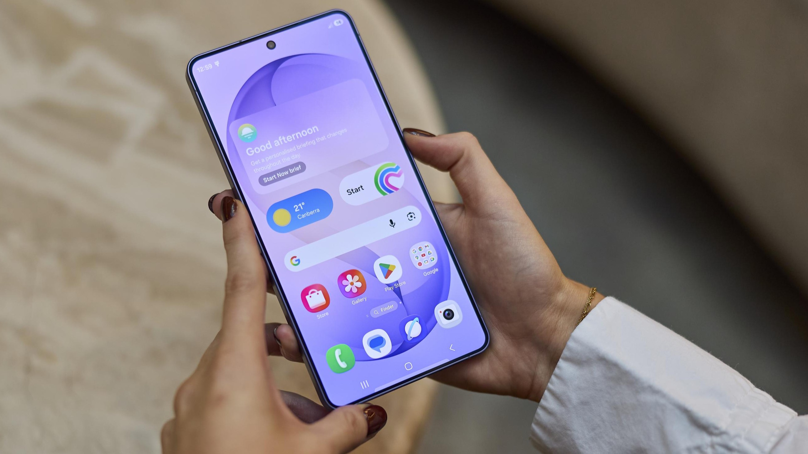 A close up of a person's hands holding a Samsung Galaxy S26 Ultra smartphone.