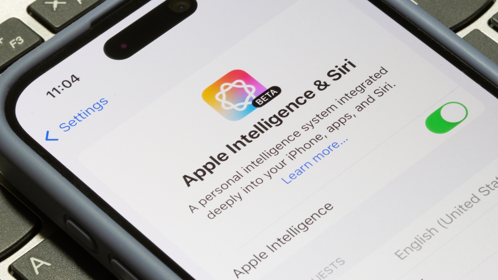 A close up of an iPhone screen displaying Apple Intelligence & Siri settings page.