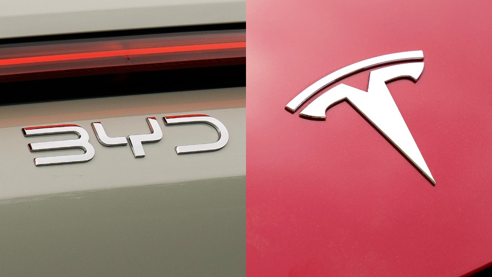 A close up of the BYD logo on the back of a car, next to a close up of the Tesla logo on a car.