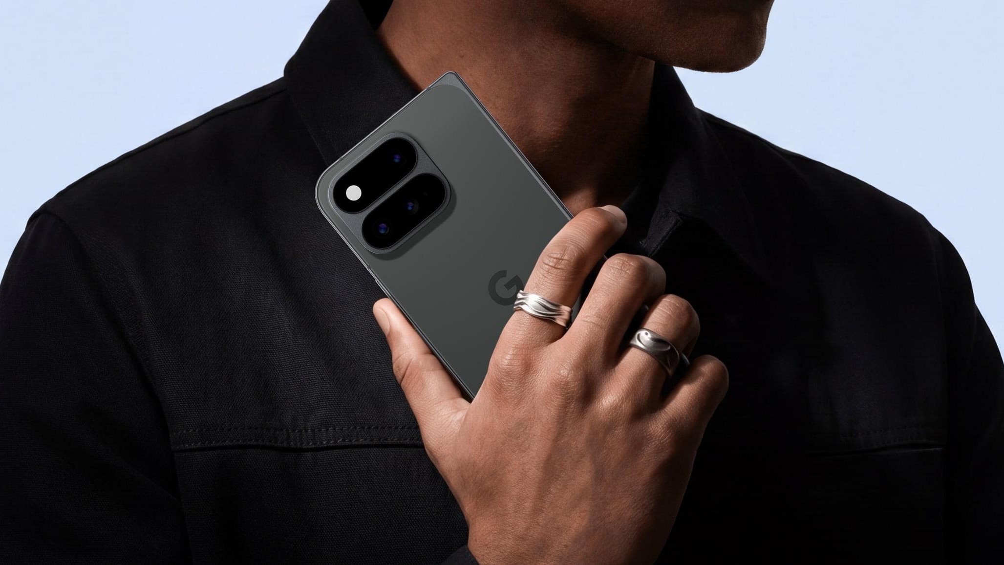 A close up of a person's hand holding a Google Pixel 11 Pro Fold smartphone.