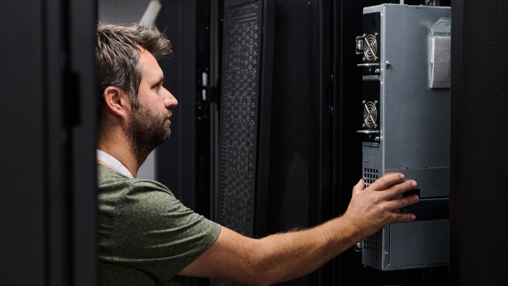 Man looking at server installation.