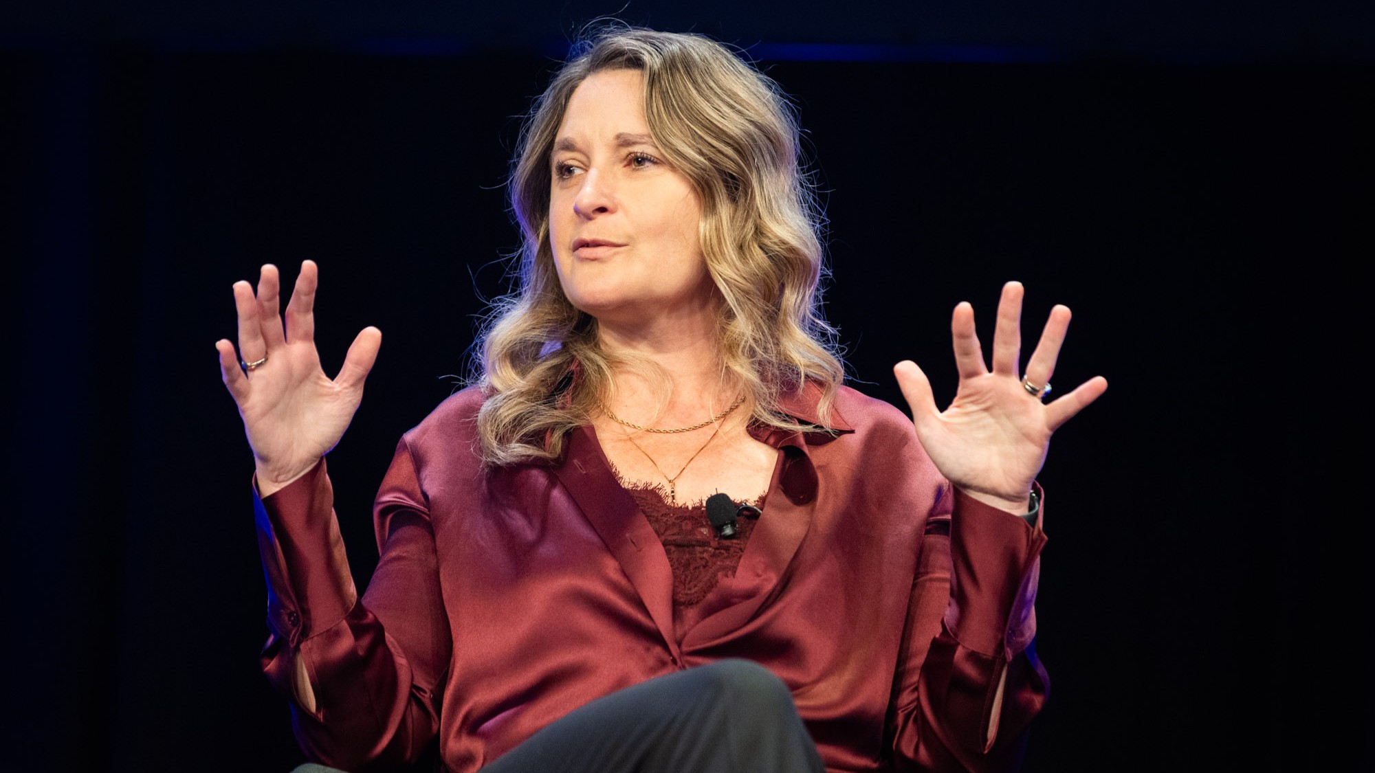 Kelly Bayer Rosmarin speaks and gestures with her hands.