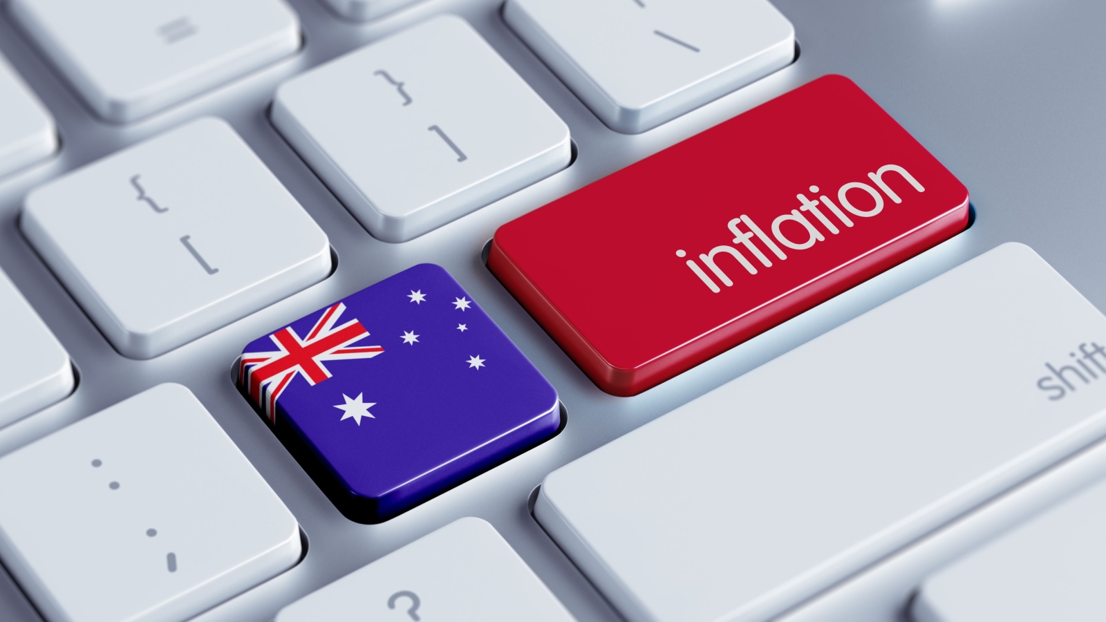 A closeup of a computer keyboard, with one key showing the Australian flag and another with the word 'inflation' on it.