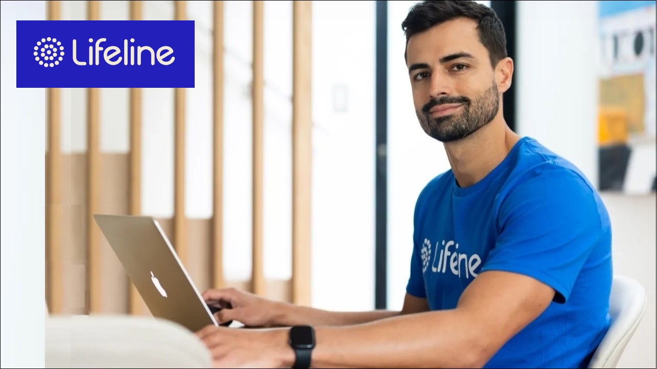 Lifeline worker sitting at a computer.