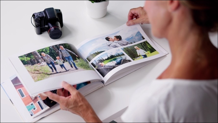 Woman flicking through a photobook.