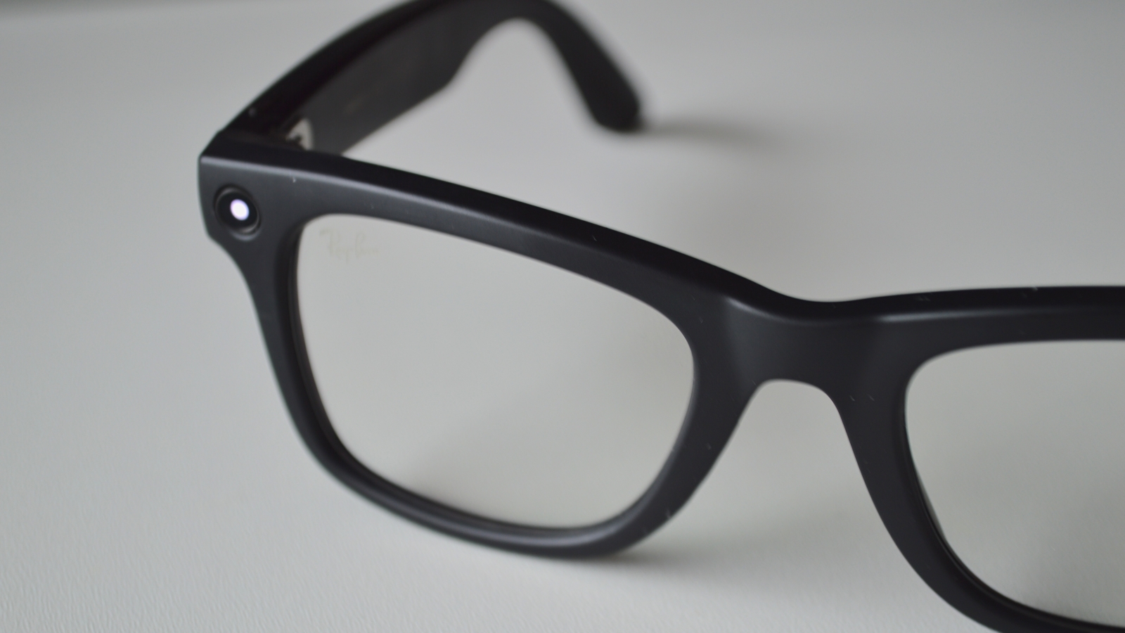 A close up of smart glasses sitting on a flat surface.