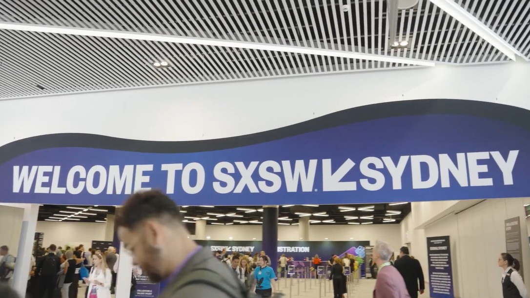 A medium shot of a sign at a conference which reads 'Welcome to SXSW Sydney'