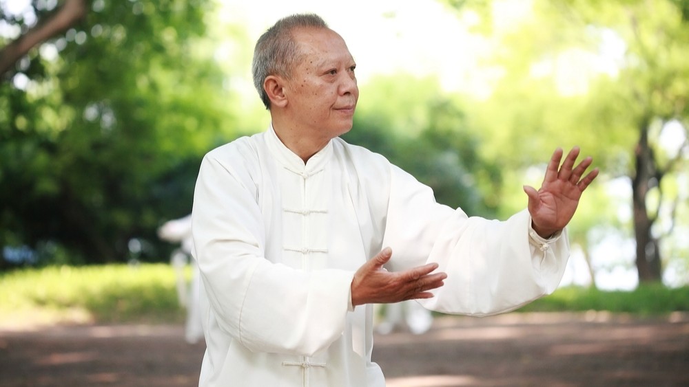 Man doing tai chi in a park.