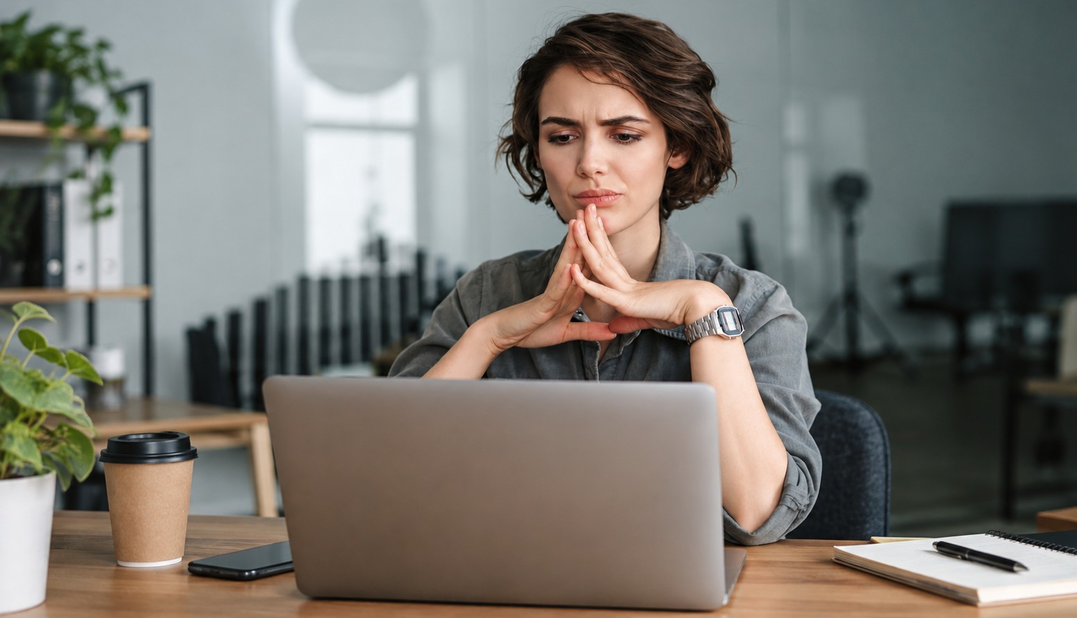 Concerned woman working on laptop.
