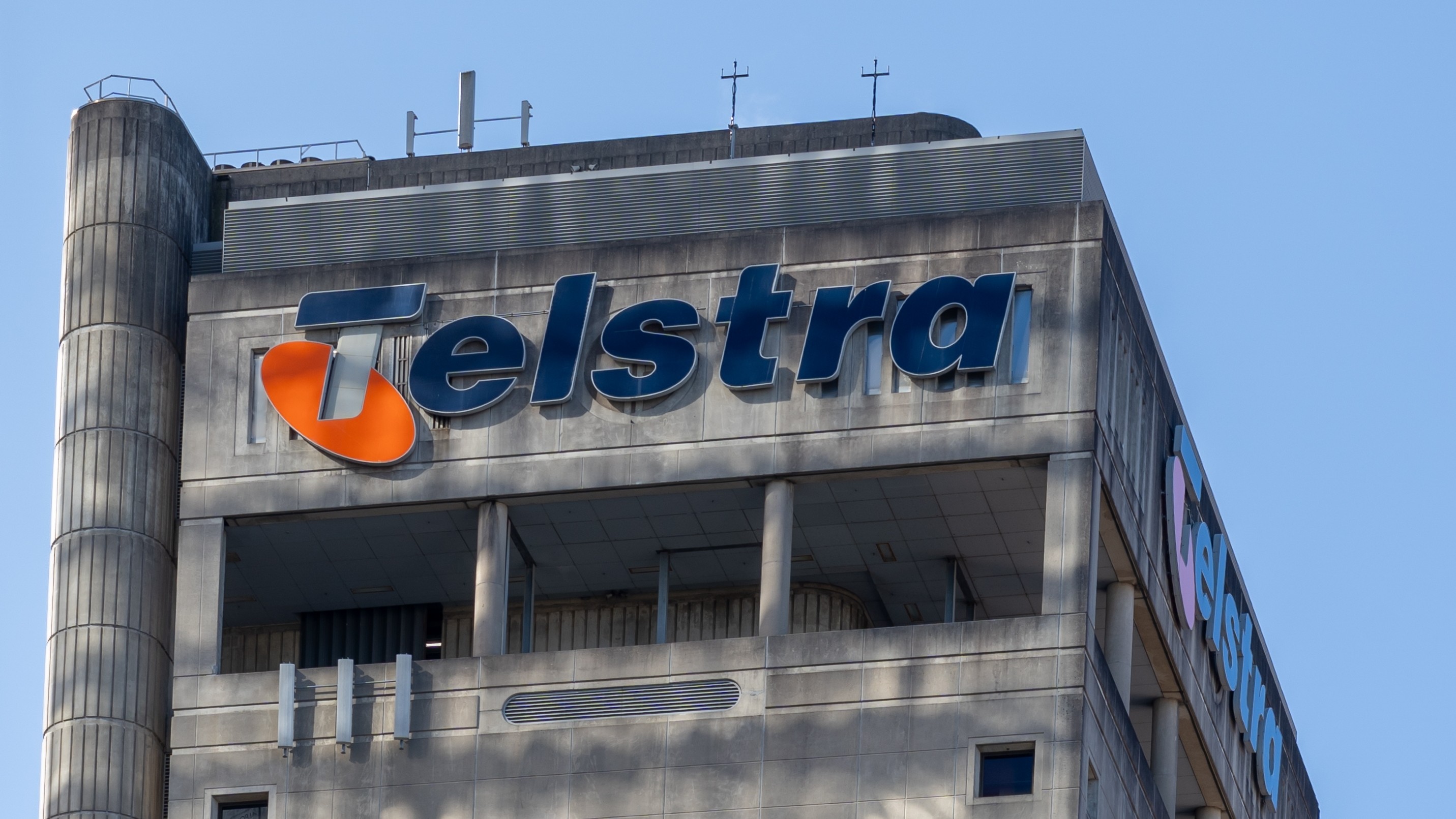 A close up of a large office building with the Telstra logo at the top.