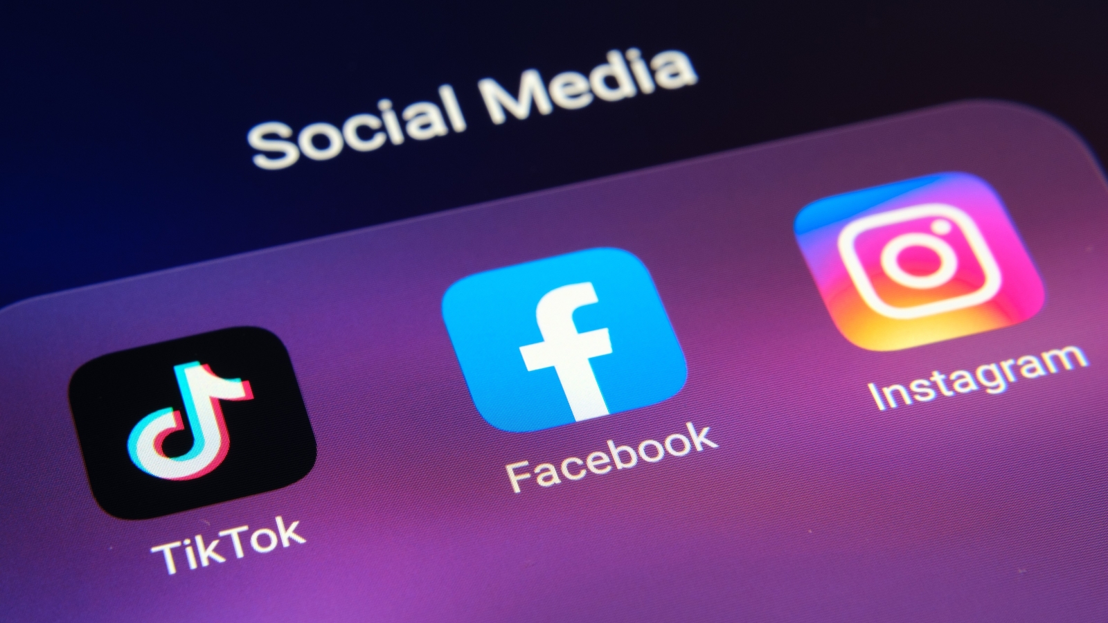 A close up of the TikTok, Facebook and Instagram apps on a smartphone screen.