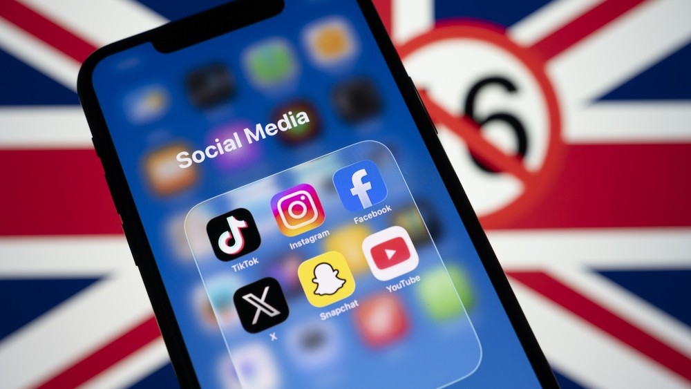 Social media apps on a phone screen with the UK flag in the background.