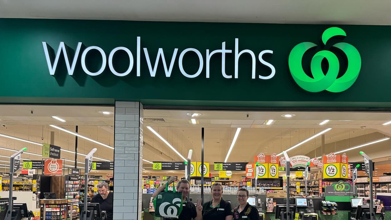 A wide shot of the front of a Woolworths supermarket.