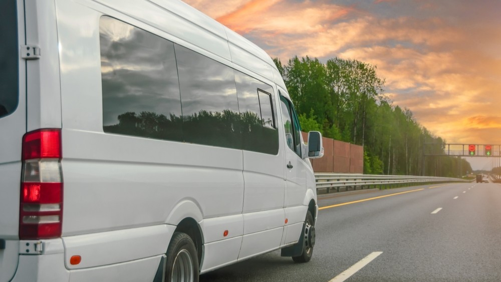 Work van travelling on the road.